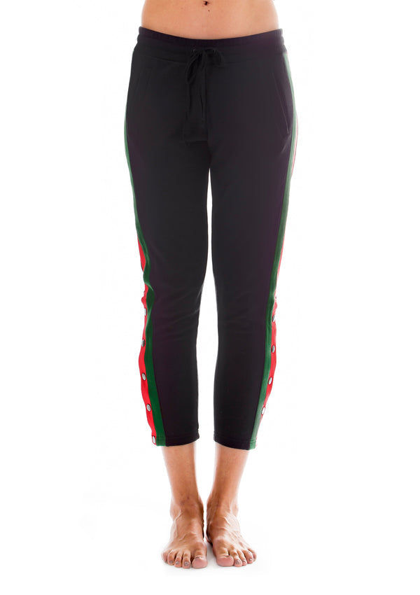 Women’s track pants in red and green tuxedo stripe design